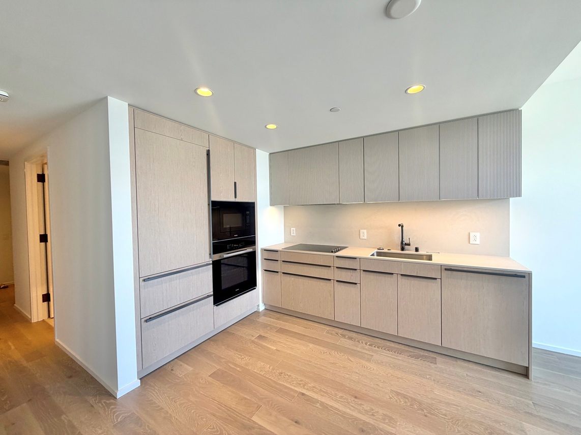 A kitchen with wooden cabinets and a sink.